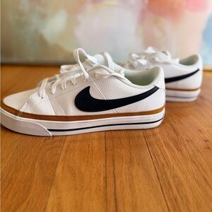 Nike White Low-Top Sneakers with Black Swoosh and Brown Accent